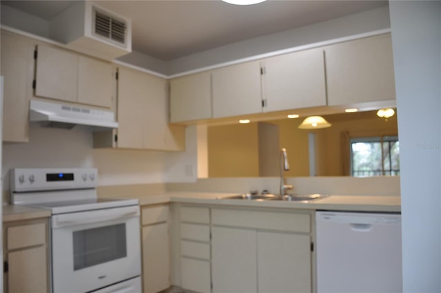 kitchen with sink, white cabinets, and white appliances