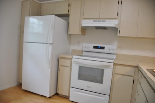 kitchen with cream cabinets, light wood-type flooring, and white appliances