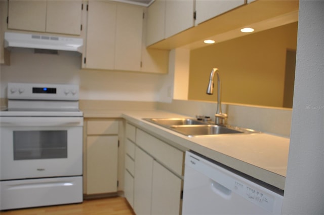 kitchen with sink, white appliances, and light wood-type flooring