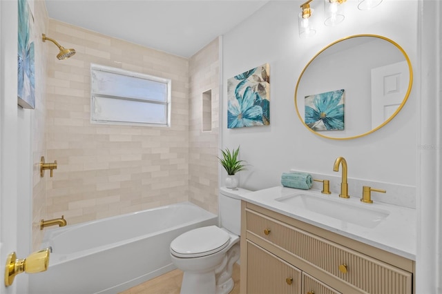 full bathroom with vanity, tiled shower / bath combo, and toilet