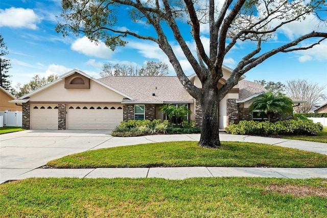 view of front of property featuring a garage and a front lawn