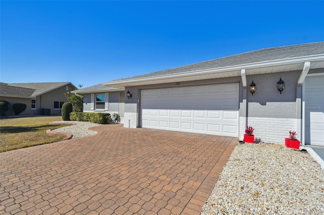 ranch-style home with a garage and a front yard