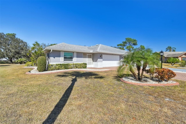 ranch-style home with a garage and a front lawn