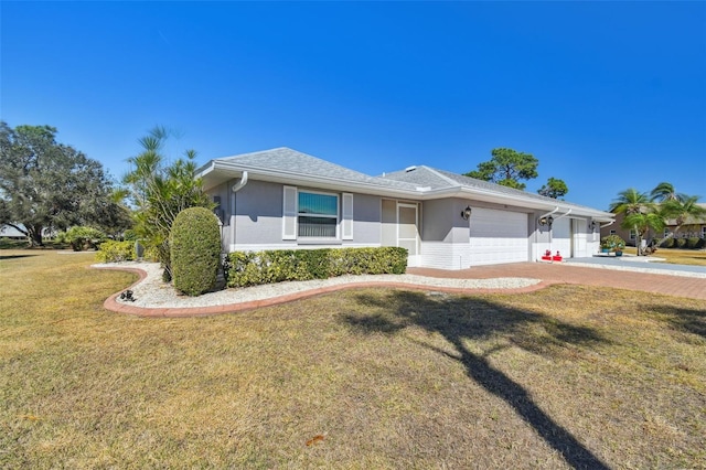 single story home featuring a garage and a front yard