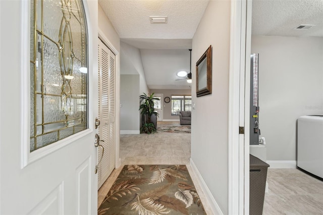 interior space with washer / dryer and a textured ceiling