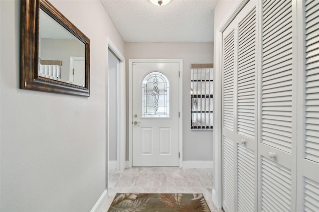 doorway featuring a textured ceiling