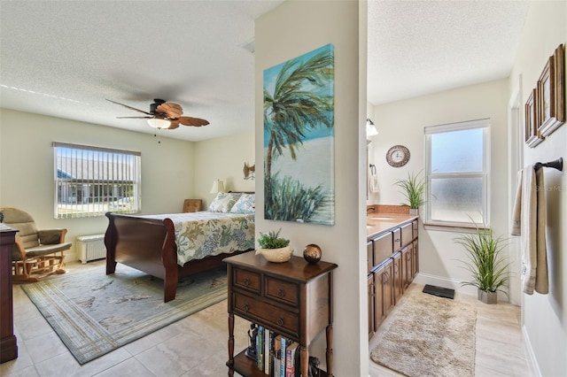 bedroom featuring multiple windows, radiator, and a textured ceiling