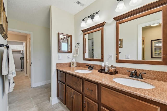 bathroom featuring vanity and a textured ceiling