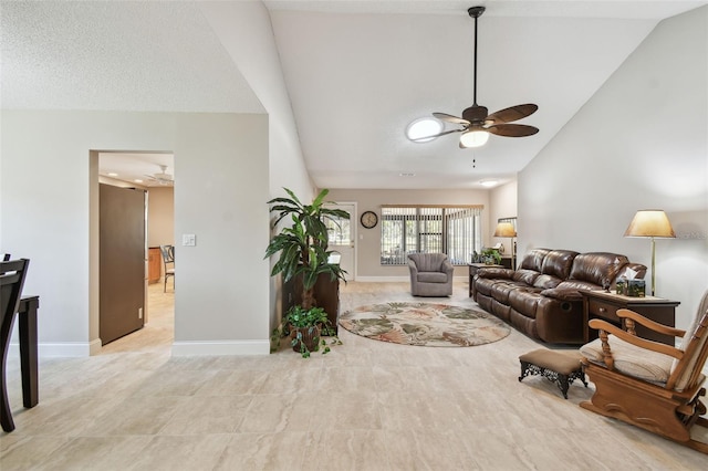 living room with ceiling fan and vaulted ceiling