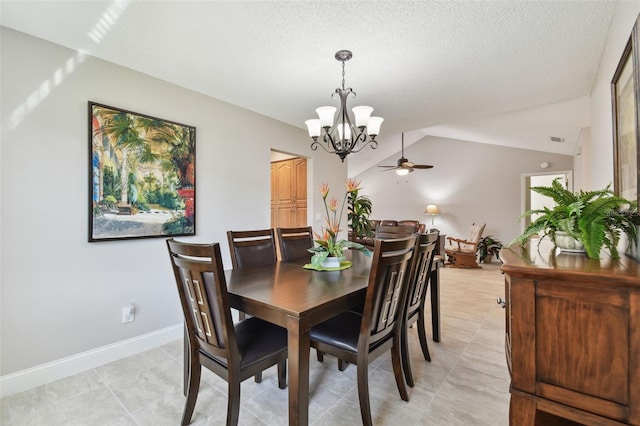 dining area featuring lofted ceiling, ceiling fan with notable chandelier, and a textured ceiling