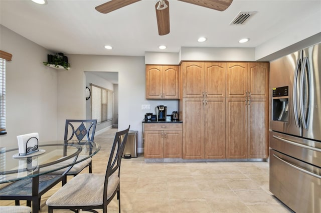 kitchen featuring ceiling fan and stainless steel refrigerator with ice dispenser