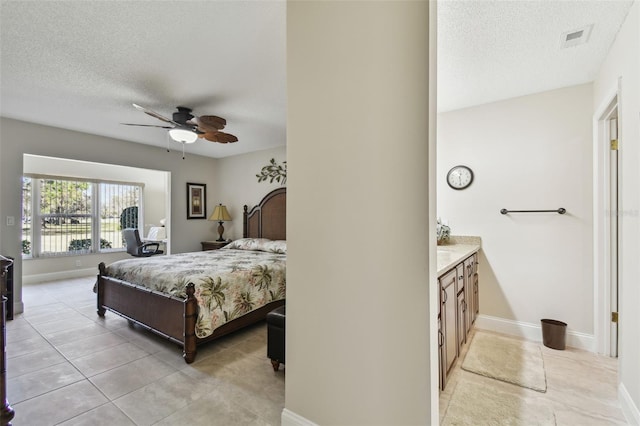 bedroom with ceiling fan, a textured ceiling, and light tile patterned floors