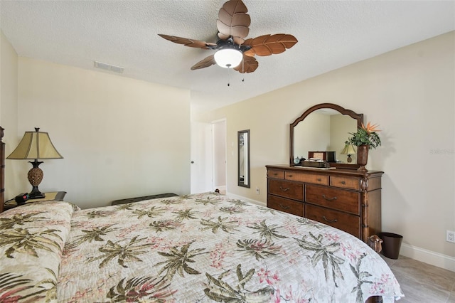 bedroom with ceiling fan and a textured ceiling