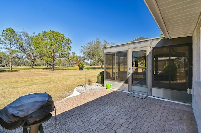 view of patio / terrace featuring a sunroom