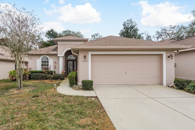 view of front facade featuring a garage and a front lawn