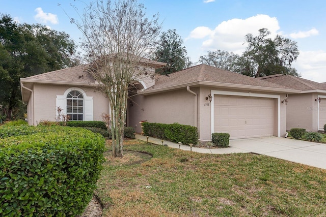 view of front facade with a garage and a front lawn