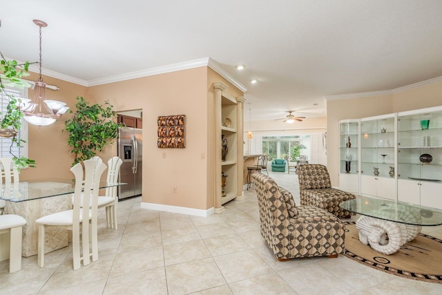 dining space featuring crown molding, ceiling fan with notable chandelier, and light tile patterned floors