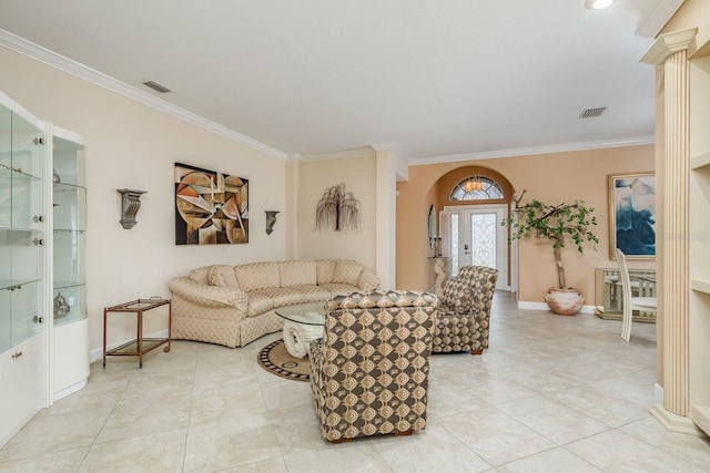 living room with light tile patterned floors, ornamental molding, and decorative columns