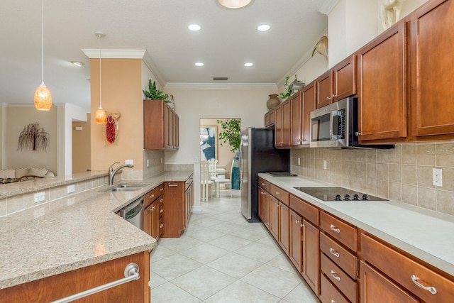 kitchen with sink, hanging light fixtures, ornamental molding, light stone counters, and stainless steel appliances