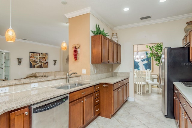 kitchen featuring pendant lighting, sink, crown molding, and appliances with stainless steel finishes