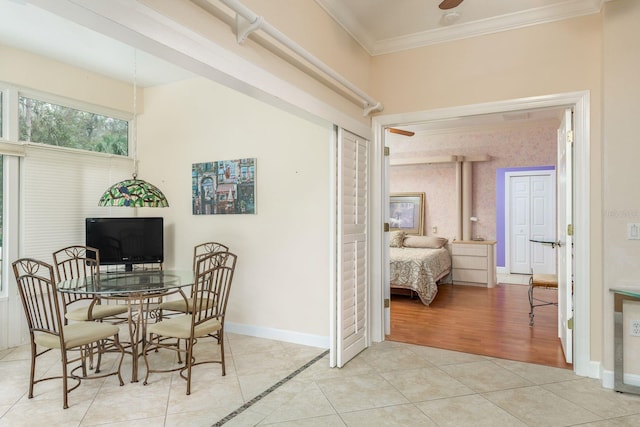 tiled dining area featuring ornamental molding