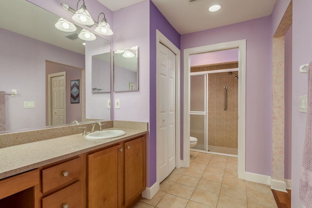 bathroom featuring walk in shower, tile patterned floors, vanity, and toilet