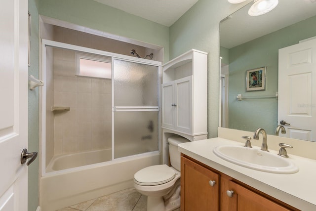 full bathroom with vanity, tile patterned floors, enclosed tub / shower combo, and toilet