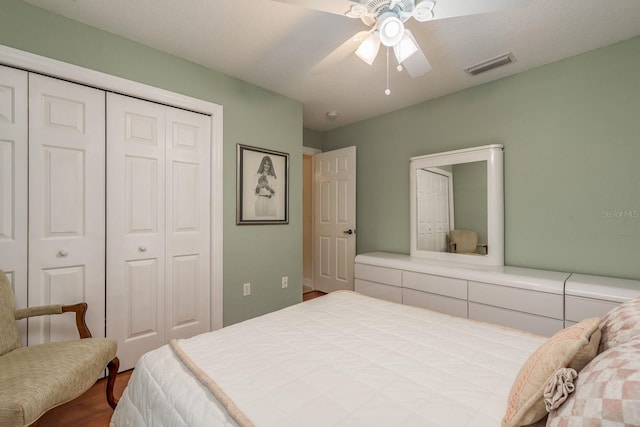 bedroom with wood-type flooring, a closet, and ceiling fan