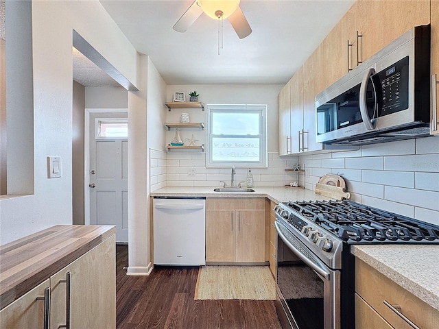 kitchen with butcher block countertops, tasteful backsplash, sink, dark hardwood / wood-style flooring, and stainless steel appliances