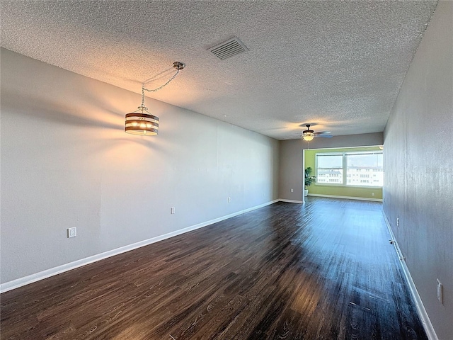 unfurnished room featuring dark hardwood / wood-style flooring, a textured ceiling, and ceiling fan