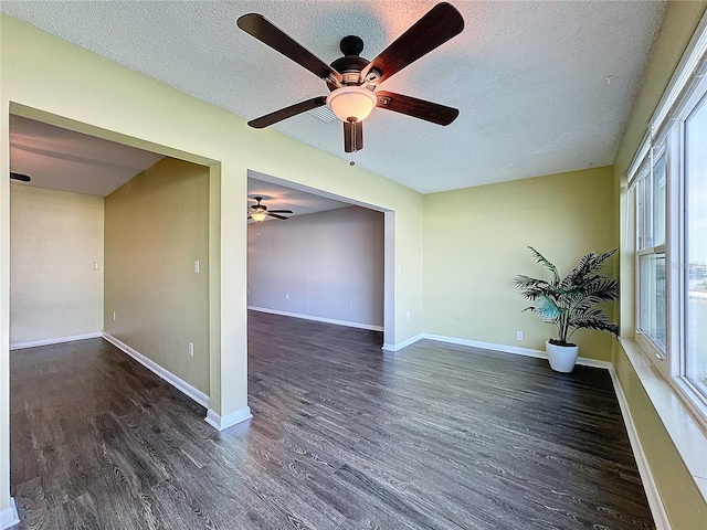 unfurnished room featuring dark hardwood / wood-style flooring and a textured ceiling