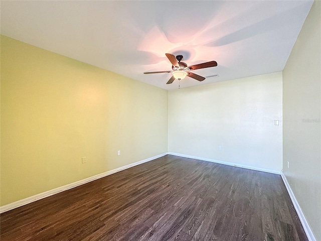 empty room featuring dark hardwood / wood-style floors and ceiling fan