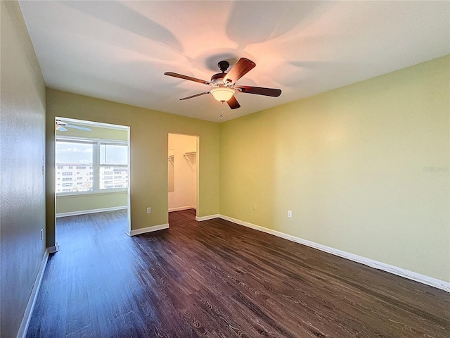 unfurnished room featuring dark hardwood / wood-style floors and ceiling fan