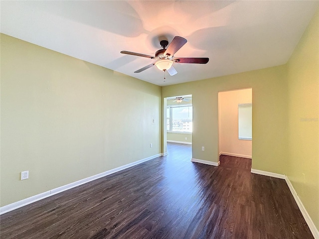 spare room featuring ceiling fan and dark hardwood / wood-style flooring