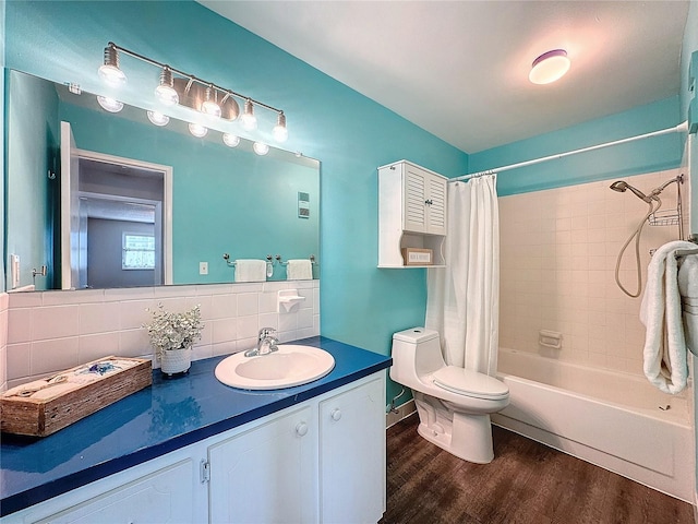 full bathroom featuring hardwood / wood-style floors, shower / bath combination with curtain, backsplash, vanity, and toilet