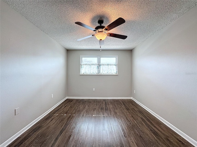 unfurnished room featuring ceiling fan, dark wood-type flooring, and a textured ceiling