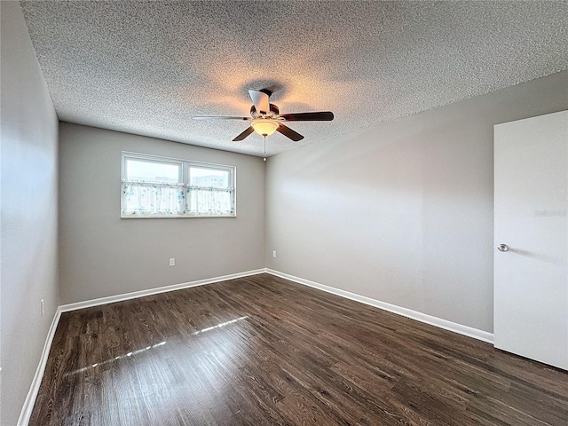 unfurnished room with ceiling fan, dark hardwood / wood-style floors, and a textured ceiling