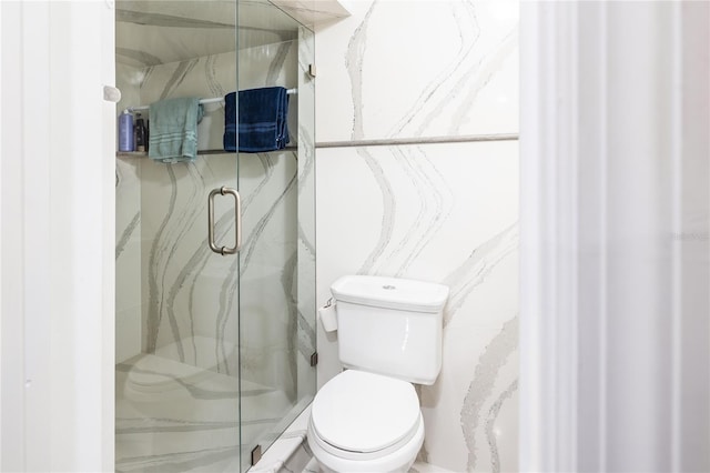 bathroom featuring an enclosed shower and toilet