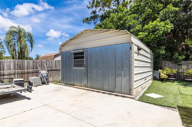 view of outbuilding featuring a yard