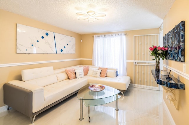 living room with tile patterned floors and a textured ceiling