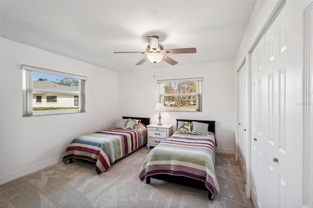 carpeted bedroom featuring a closet and ceiling fan