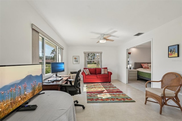 tiled office space featuring ceiling fan