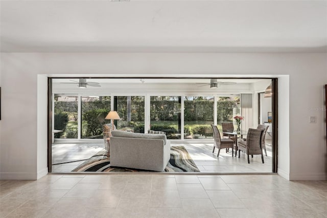 tiled living room with ceiling fan