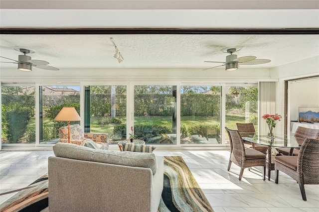 sunroom with a wealth of natural light and ceiling fan