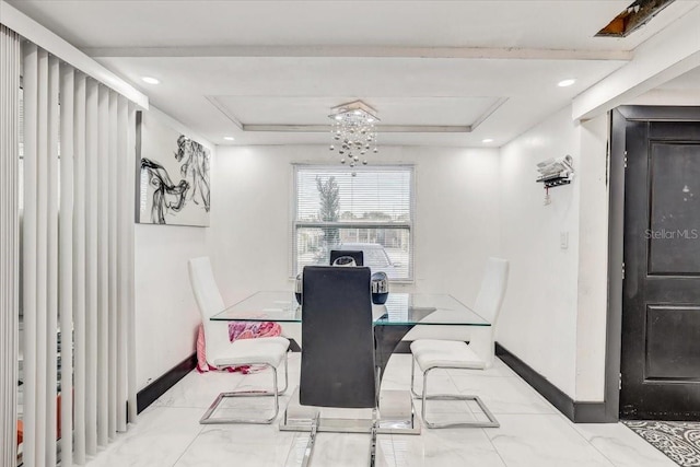 dining space with a raised ceiling