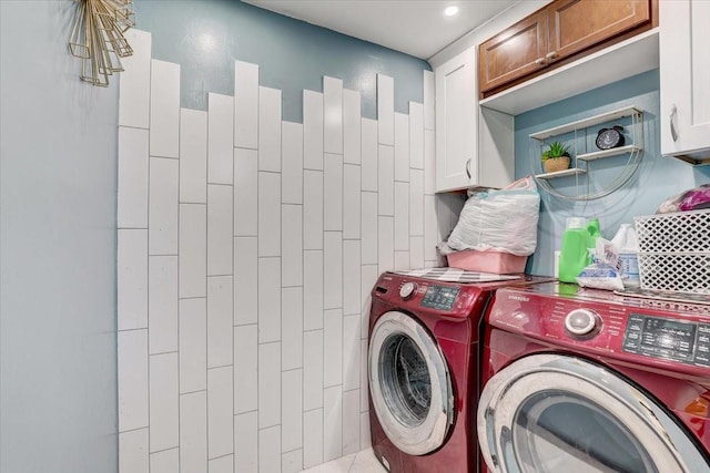 laundry room featuring cabinets and washing machine and clothes dryer