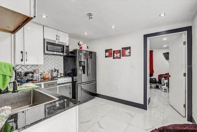 kitchen with white cabinetry, backsplash, sink, and appliances with stainless steel finishes