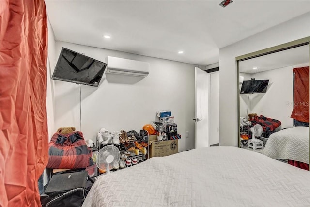 bedroom with a wall mounted AC and ceiling fan