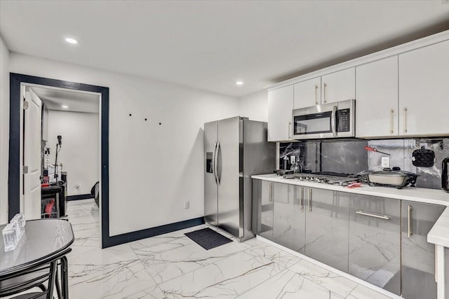 kitchen with white cabinetry, tasteful backsplash, and appliances with stainless steel finishes