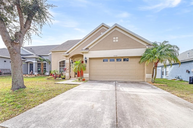 ranch-style house featuring a garage and a front lawn